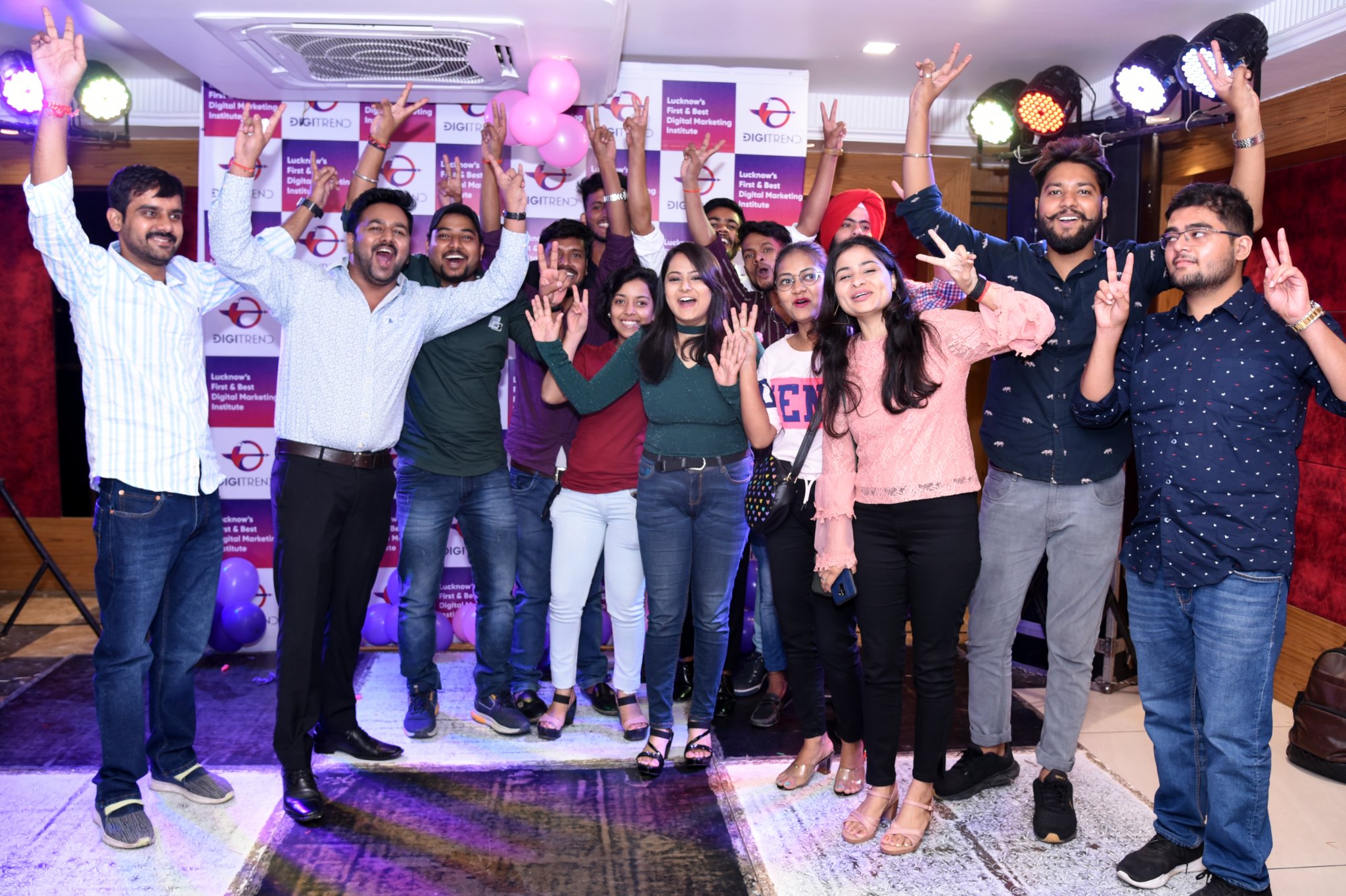 A group of people smiling and posing for a photo while celebrating DigiTrend’s 10 years of successfully teaching digital marketing in Lucknow.
